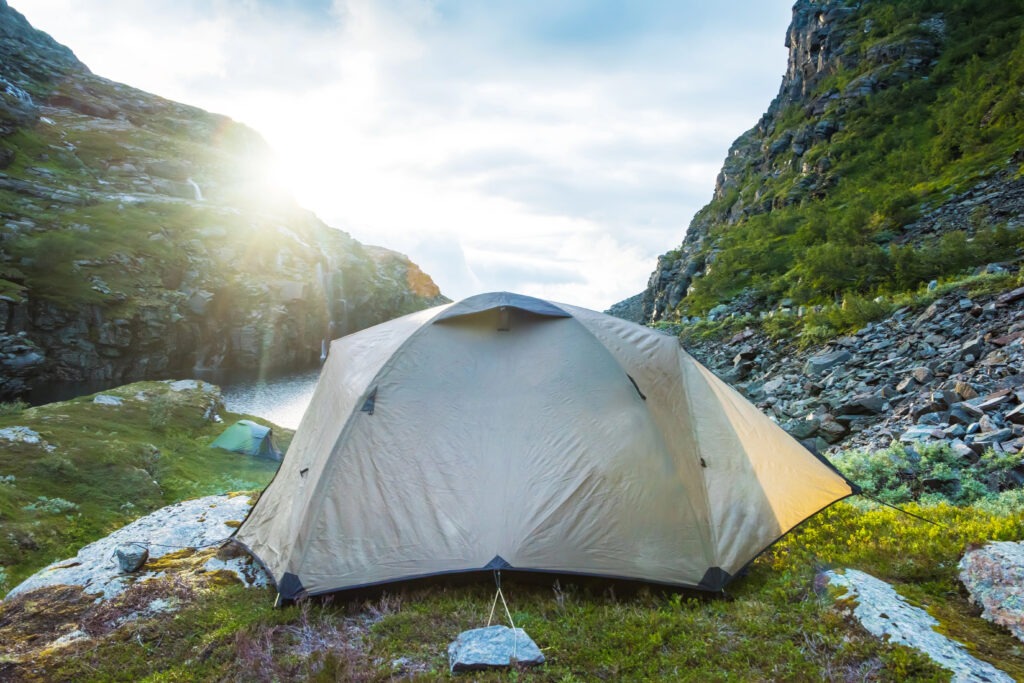 A tent in the middle of a rocky valley
