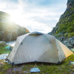 A tent in the middle of a rocky valley