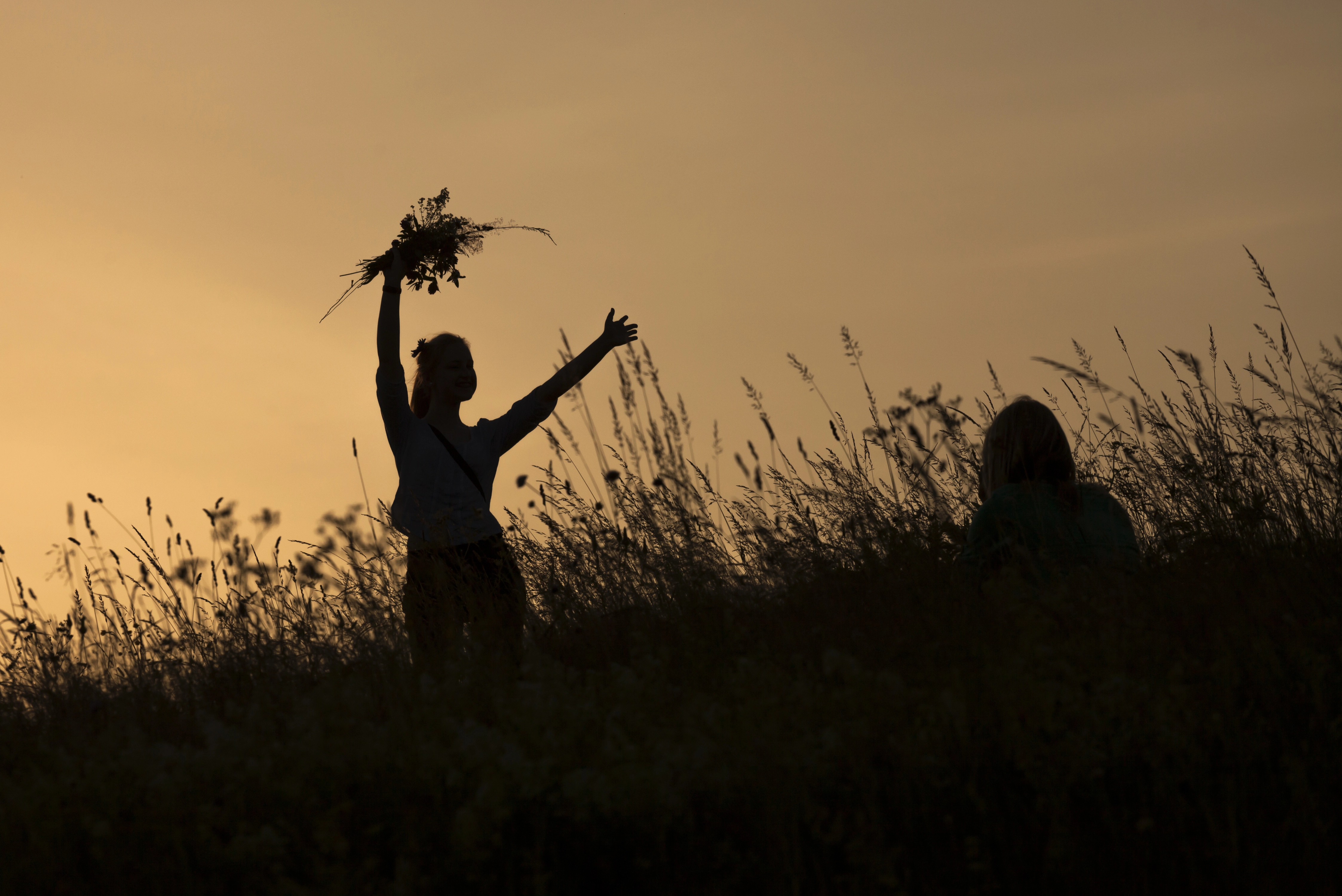 A woman holding a solstice ritual at sunrise.