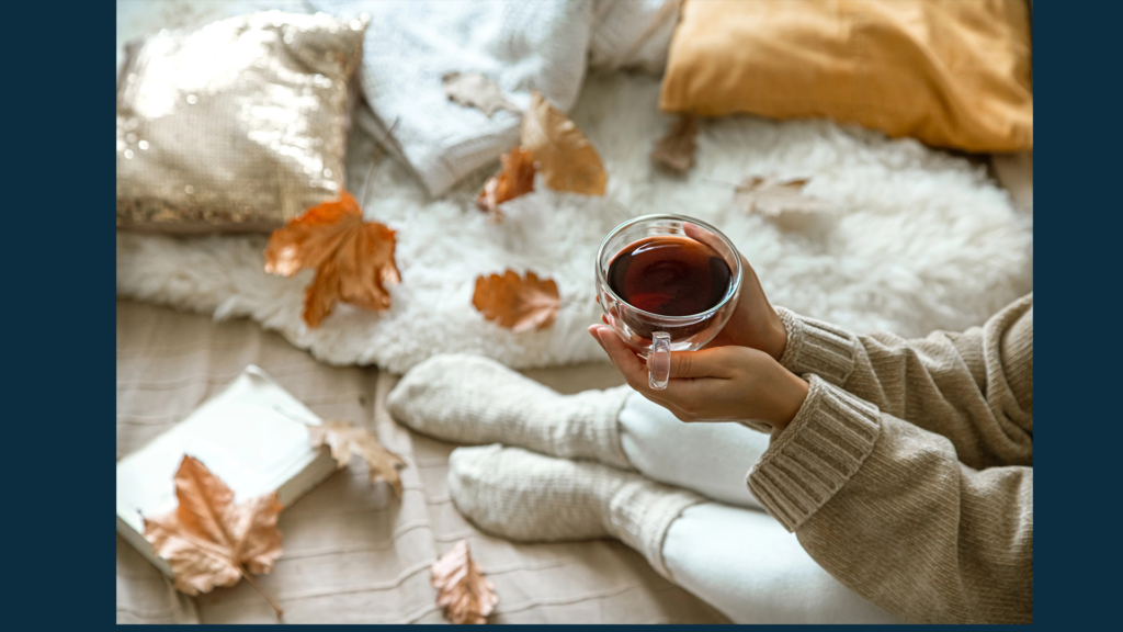 Cozy journaling setup with notebook, candle, and tea for creative homemakers and writers.
