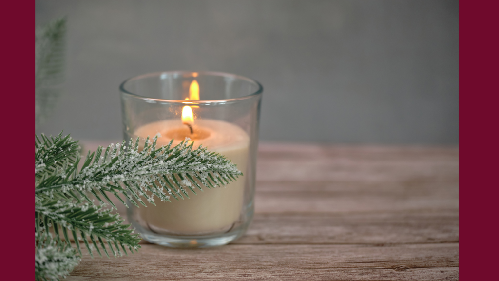 Candlelight and evergreens representing shared winter holiday symbolism across Yule, Christmas, and Hanukkah