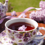 Spring tea party table decorated with flowers for an Ostara spring equinox celebration